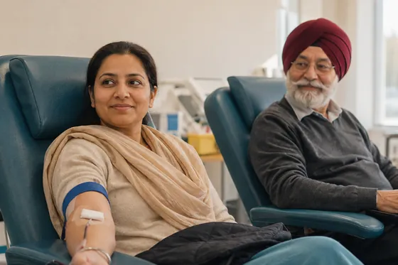 A person resting after giving blood in a clinic chair, another donor seated alongside